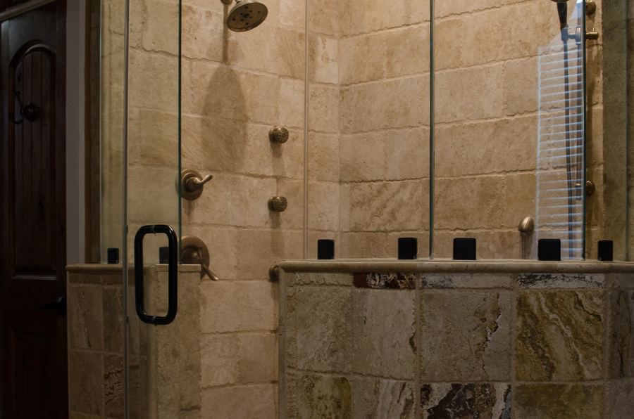 Tiled walk-in shower with glass door